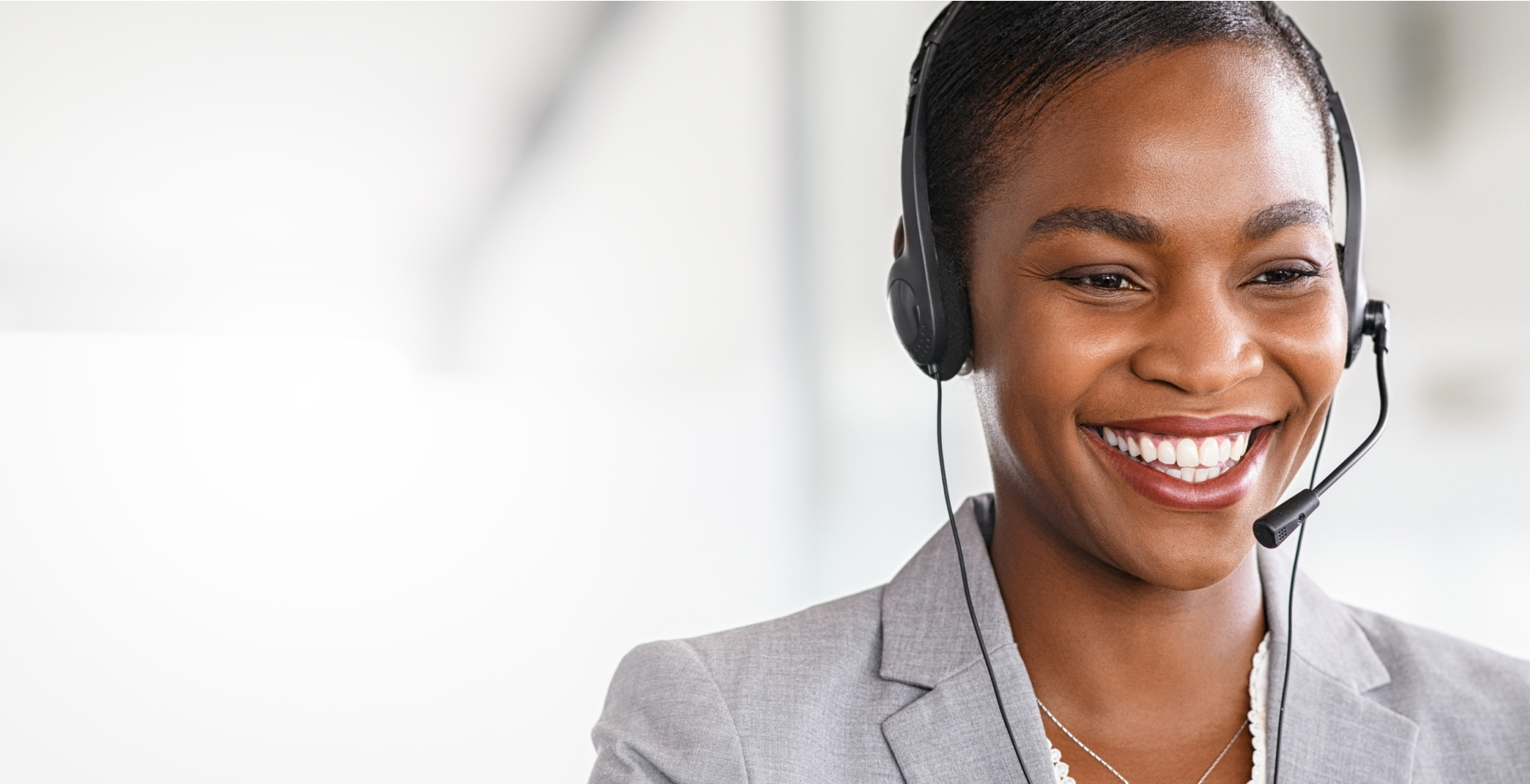 A Tosa support specialist wearing a headset and smiling