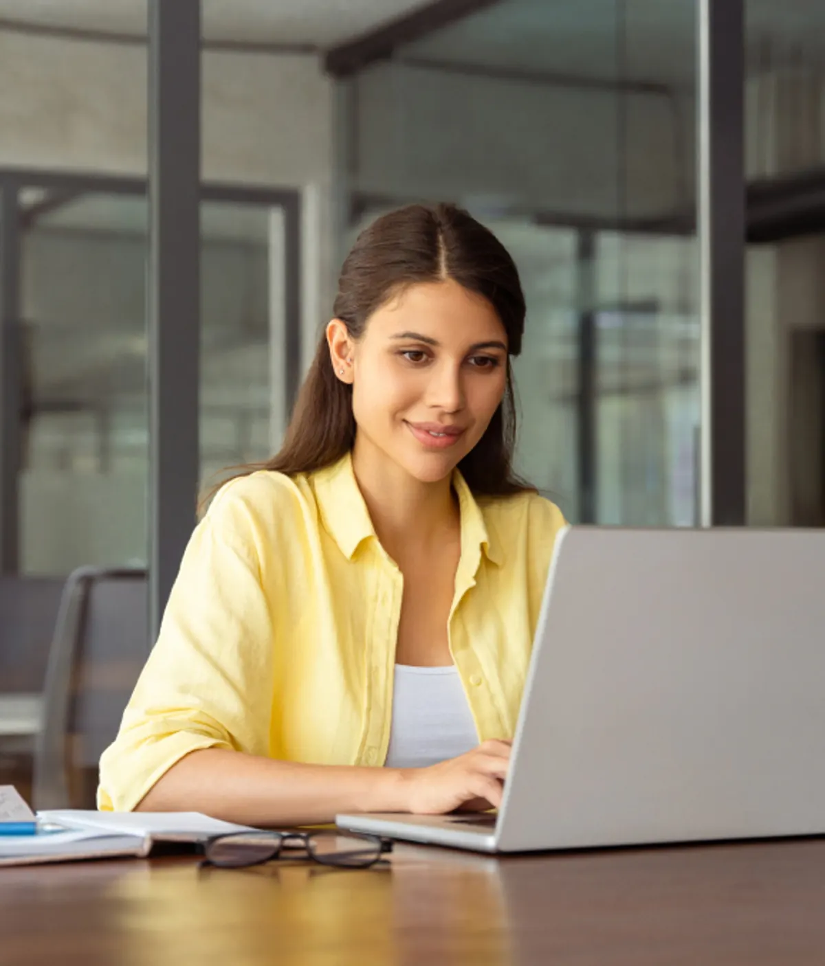 A candidate selecting her exam options on a laptop